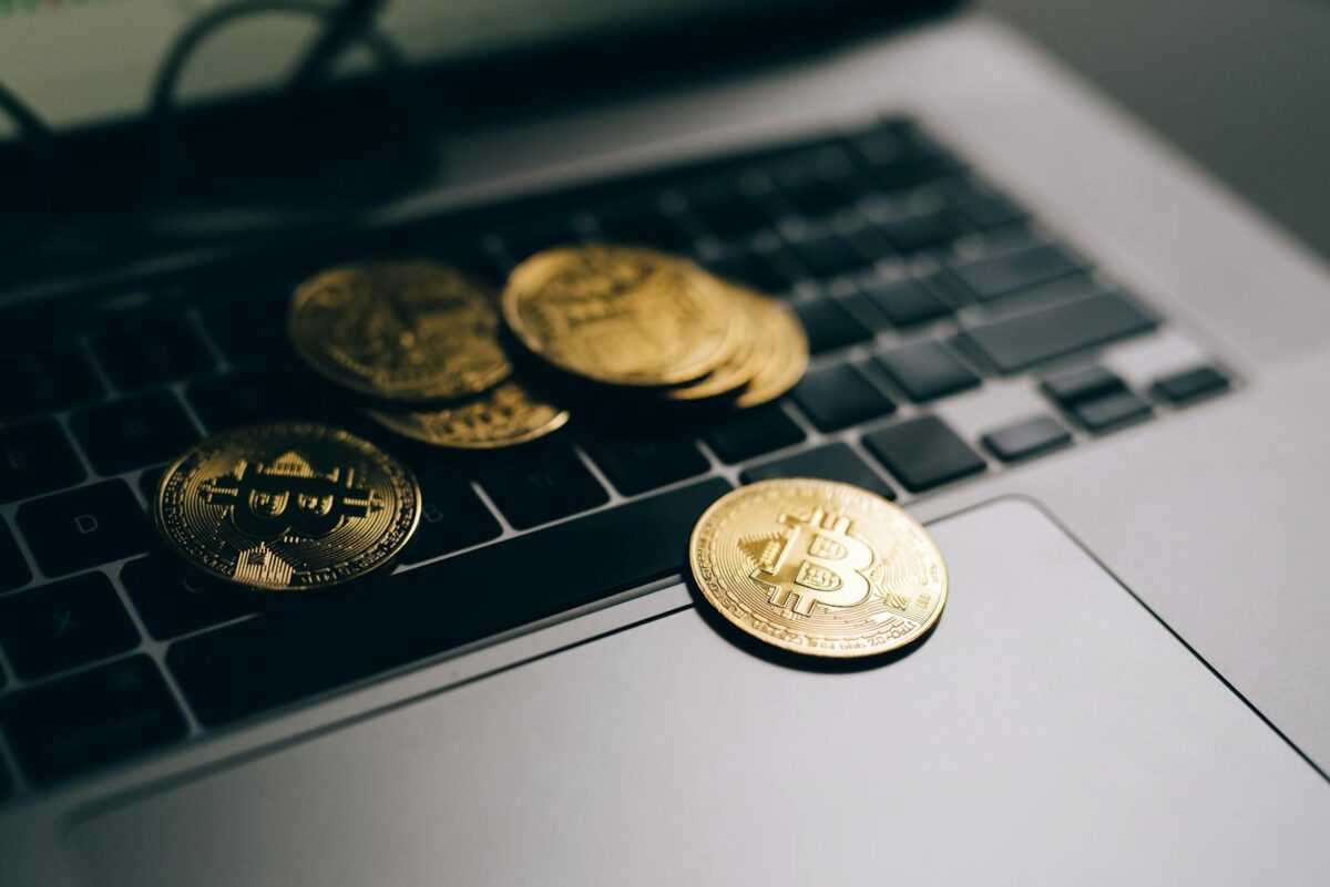 Close-up of golden Bitcoins placed on a laptop keyboard, symbolizing digital currency and modern finance.