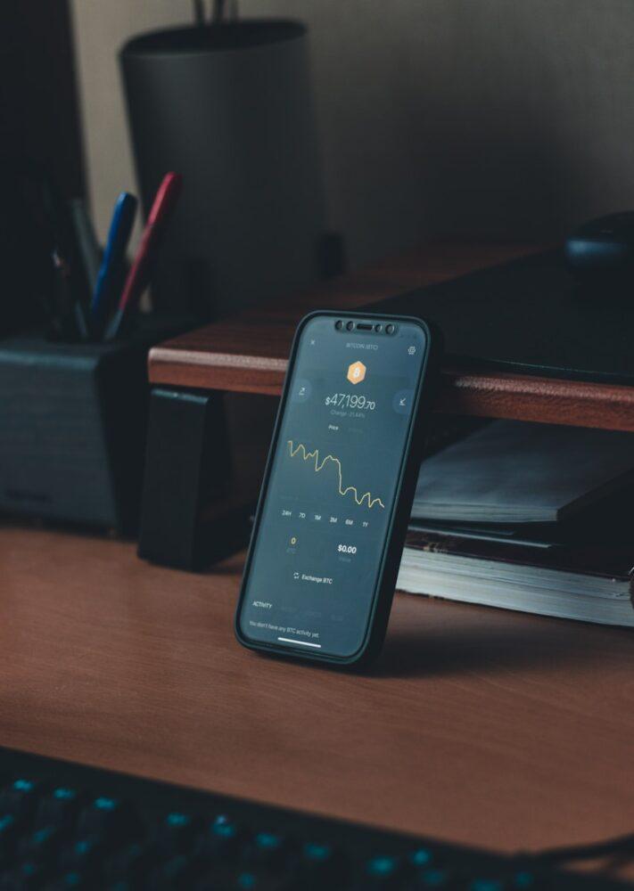 a cell phone sitting on top of a wooden desk